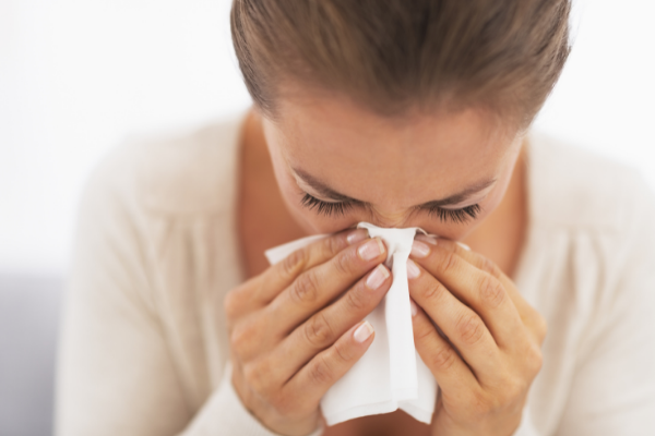 woman blowing her nose